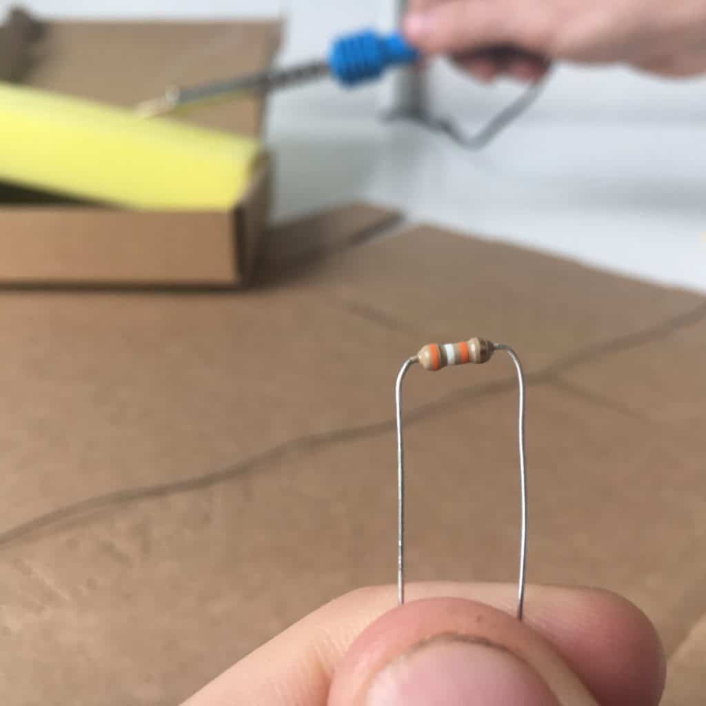 bent resistor held in hand