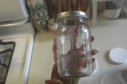 hand holding mason jar
