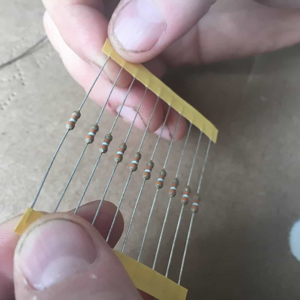 holding a set of resistors in hand
