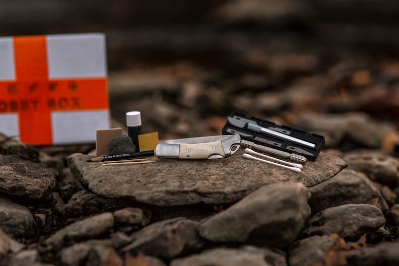 scrimshaw kit laying on a stone in a forest